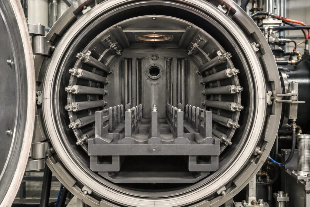 Graphite components installed inside a vacuum furnace for high-temperature heat treatment applications.